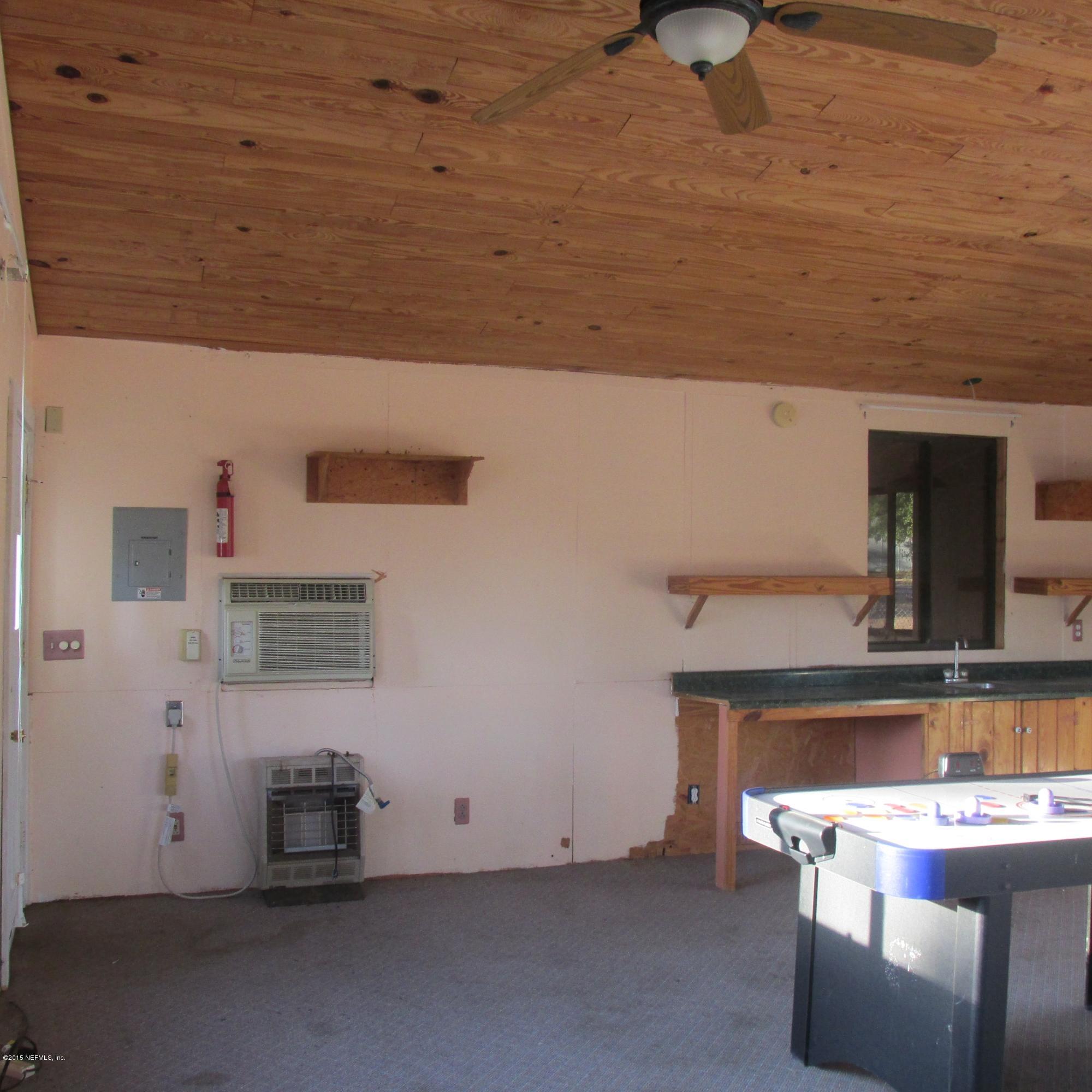 6841 Deer Springs Road Keystone Heights, FL 32656 - Photo 23 of 27 a view of kitchen with stainless steel appliances wooden floor and table chairs
