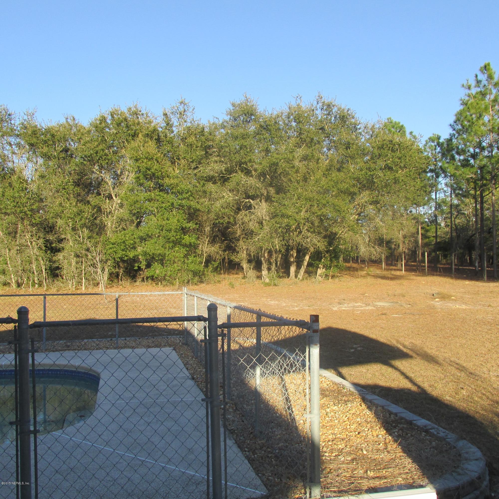 6841 Deer Springs Road Keystone Heights, FL 32656 - Photo 26 of 27 a view of a swimming pool with an outdoor seating