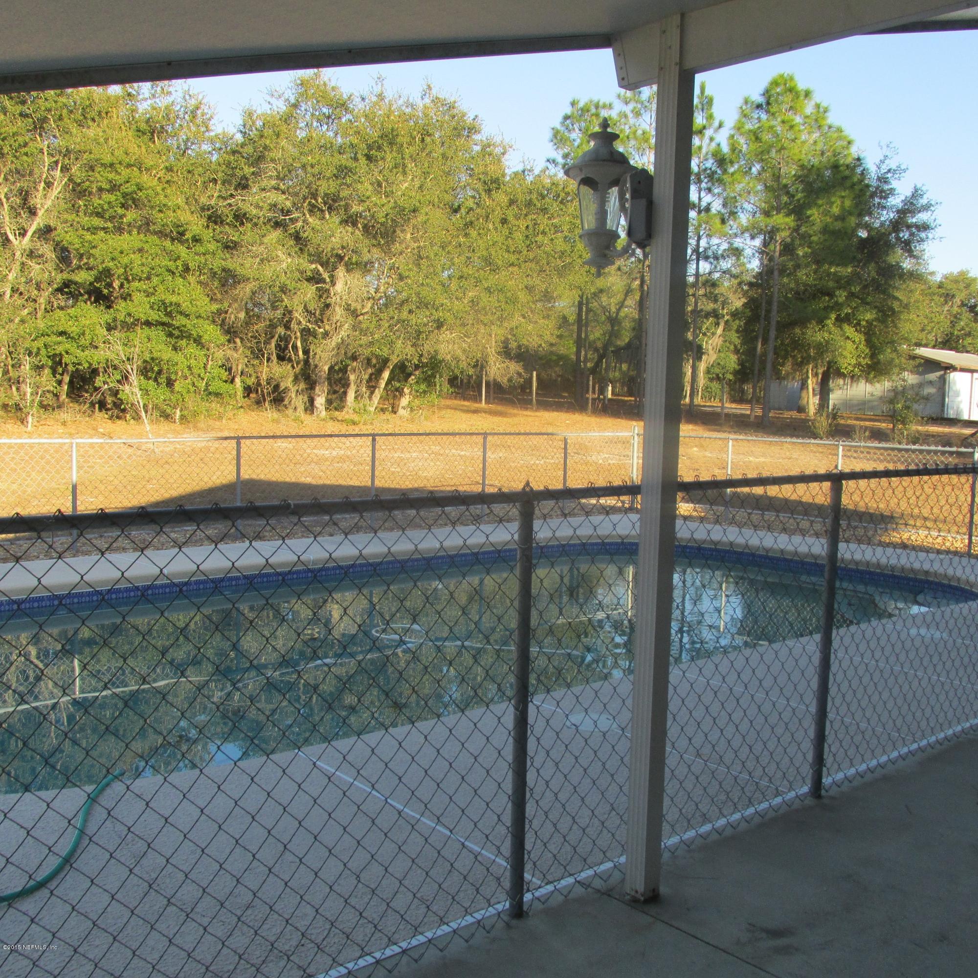 6841 Deer Springs Road Keystone Heights, FL 32656 - Photo 4 of 27 a view of a yard with an outdoor seating
