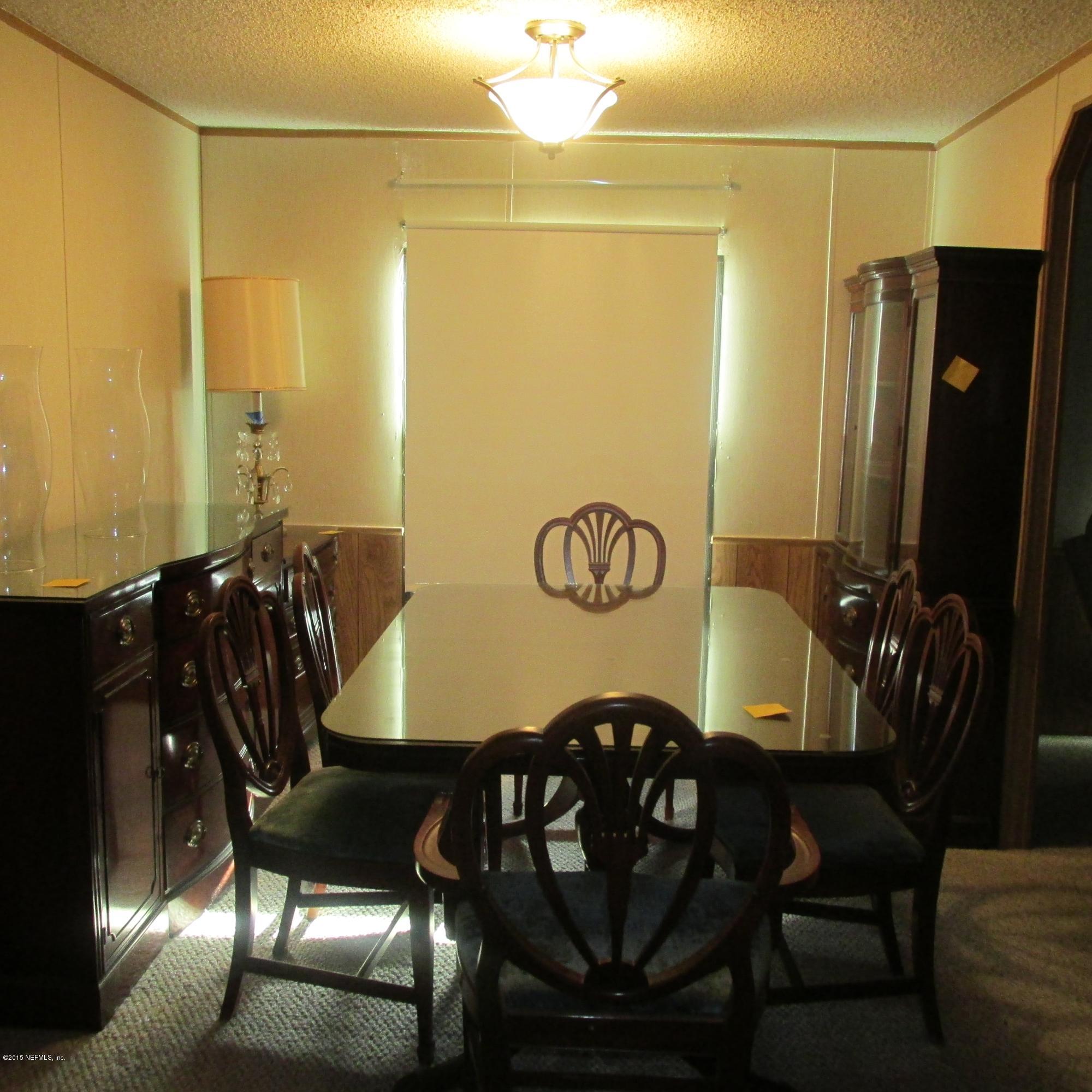 6841 Deer Springs Road Keystone Heights, FL 32656 - Photo 10 of 27 a view of a dining room with furniture