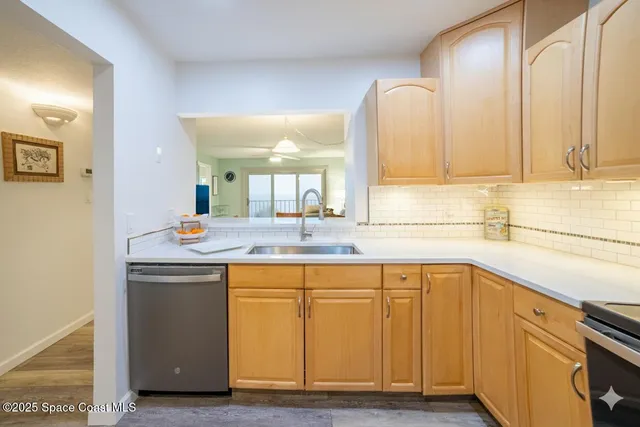 a view of a kitchen with sink and mirror