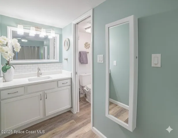 a bathroom with a double vanity sink mirror and shower
