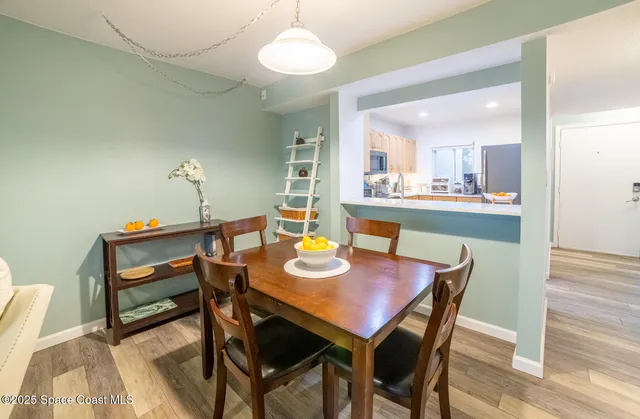 a view of a dining room with furniture and wooden floor