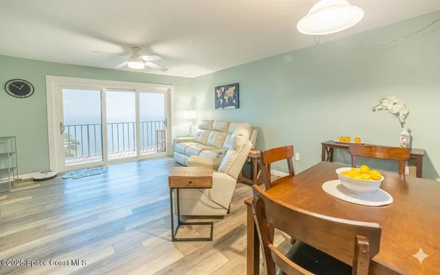 a living room with dining table and wooden floor