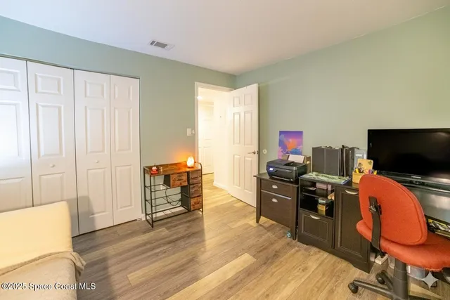 a bedroom with furniture and wooden floor