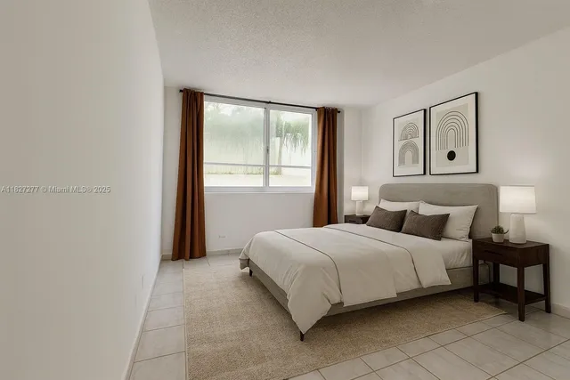 a bedroom with a bed and a night stand