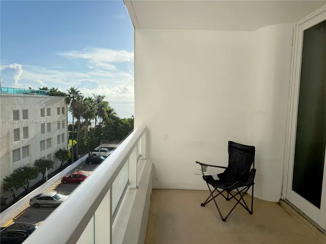 a balcony with table and chairs