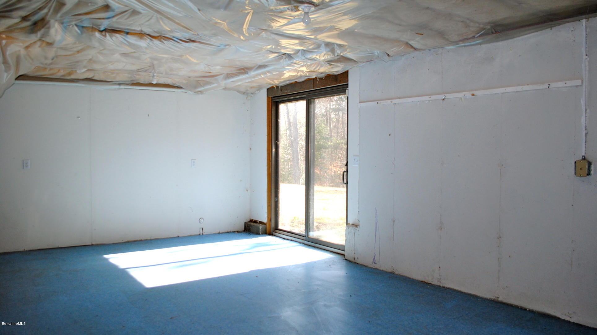 919 Fred Snow Road Becket, MA 01223 - Photo 16 of 23 an empty room with wooden floor and windows