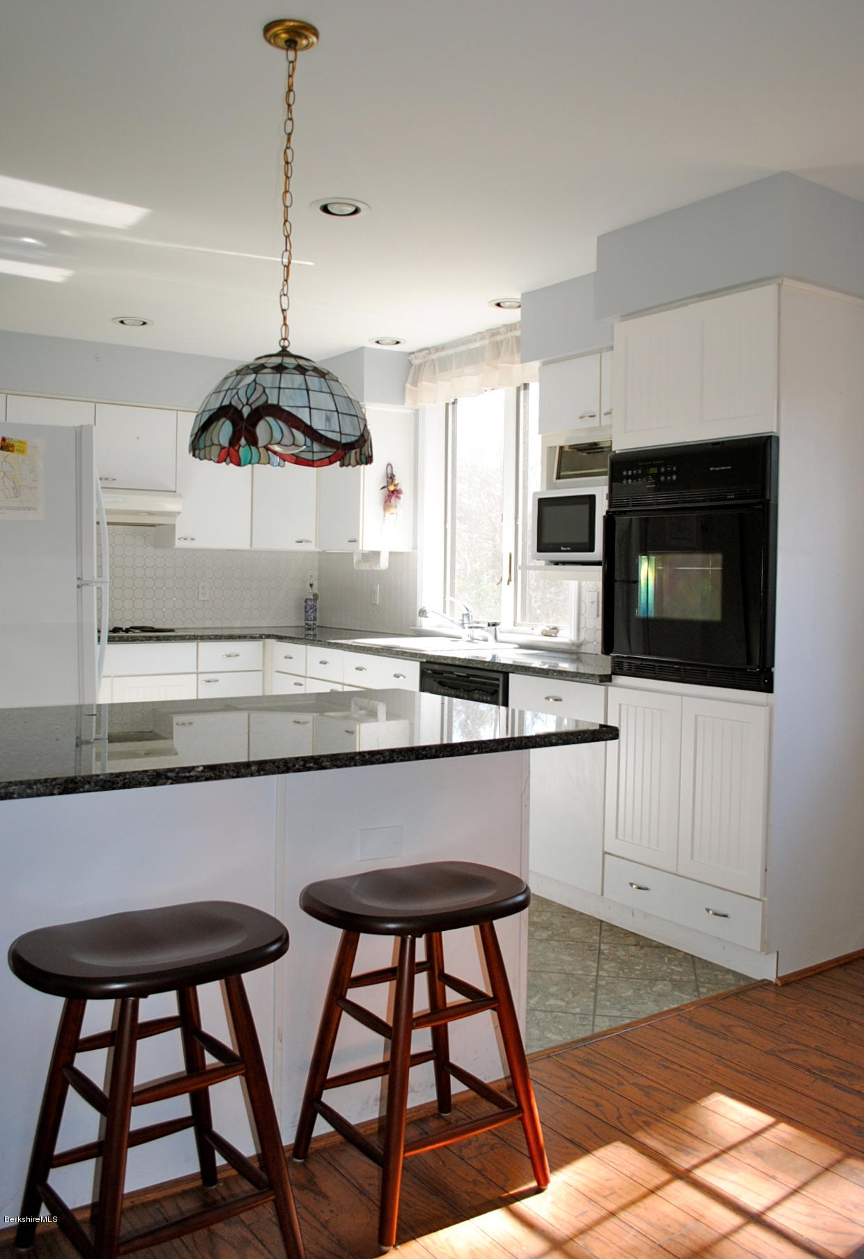 919 Fred Snow Road Becket, MA 01223 - Photo 9 of 23 a kitchen with stainless steel appliances granite countertop a stove a sink and a microwave