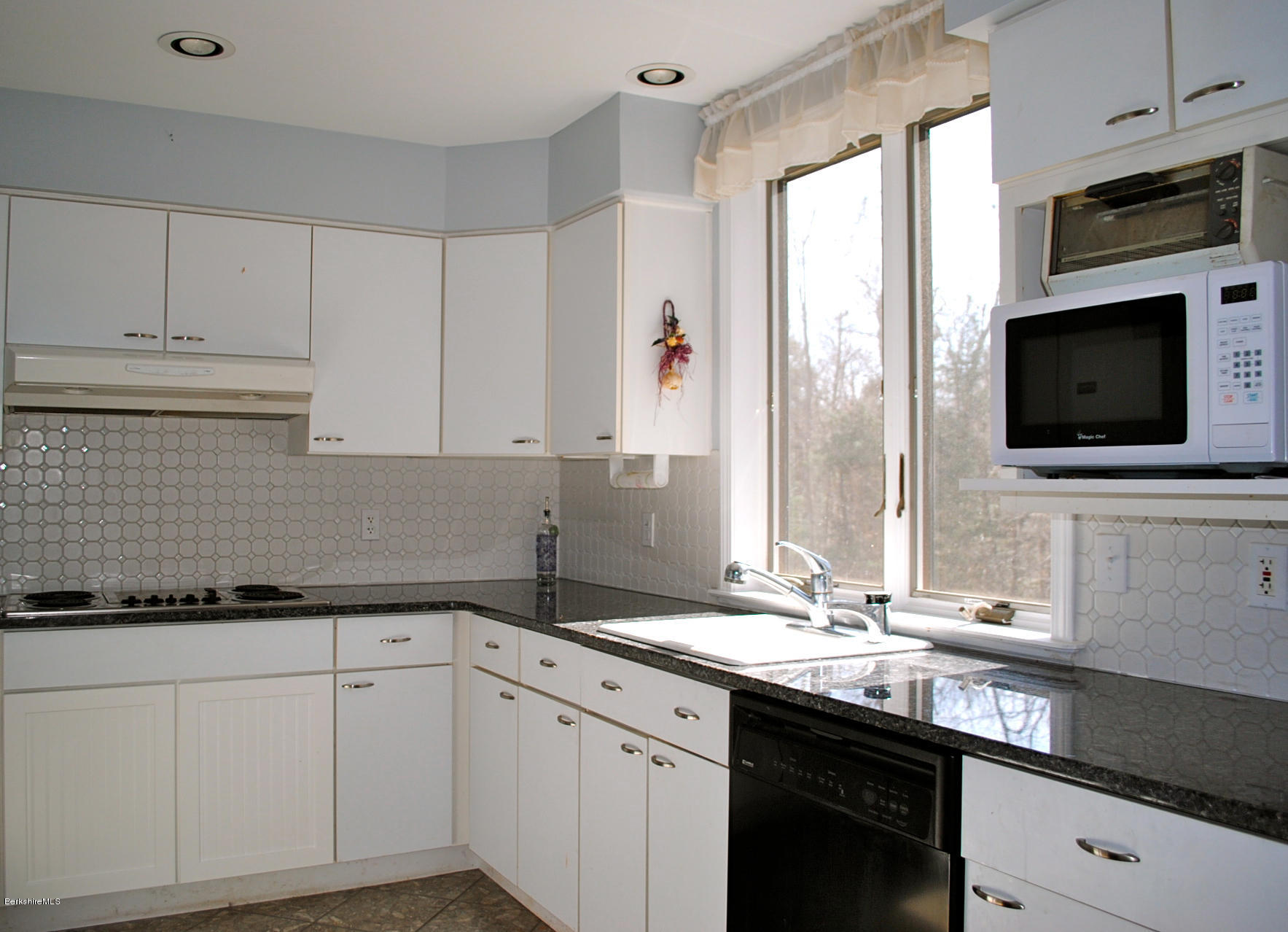 919 Fred Snow Road Becket, MA 01223 - Photo 10 of 23 a kitchen with stainless steel appliances white cabinets a sink and a oven