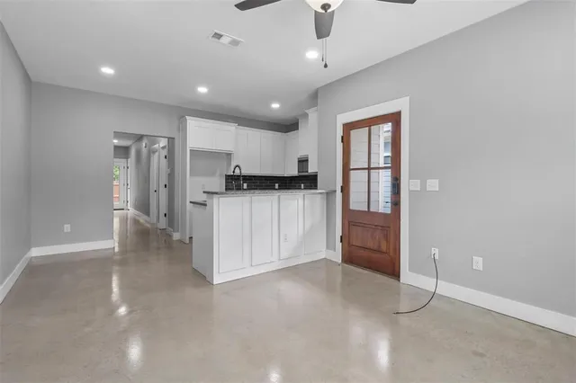a view of a kitchen with a sink and a refrigerator