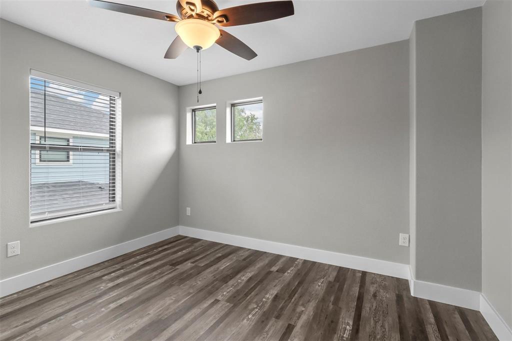 1401 South 5th Avenue, Unit 1401 Denison, TX 75021 - Photo 7 of 16 a view of an empty room with wooden floor and a window