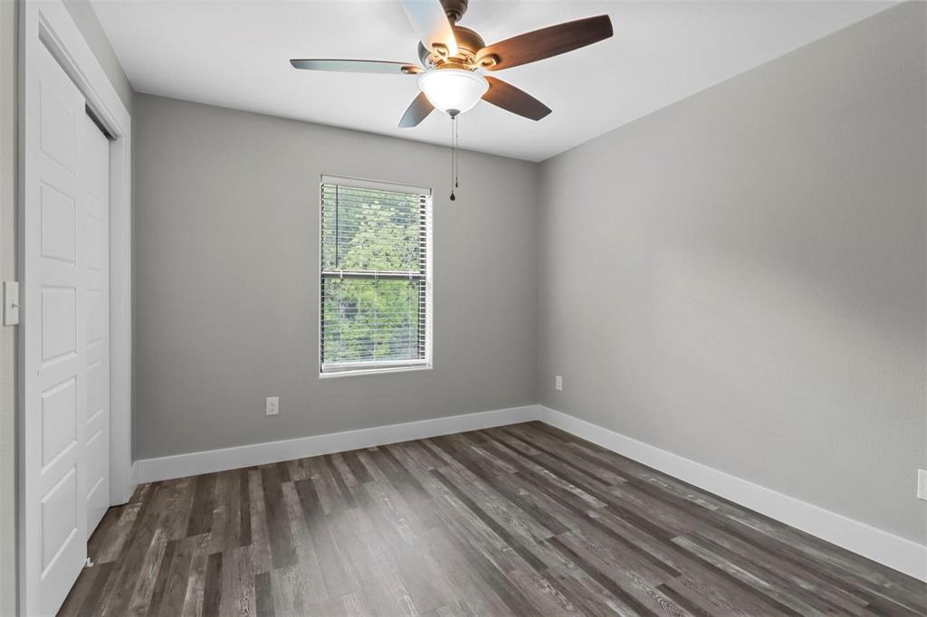 1401 South 5th Avenue, Unit 1401 Denison, TX 75021 - Photo 9 of 16 wooden floor in an empty room with a window