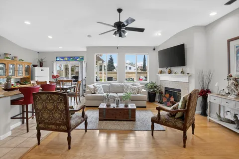 a living room with furniture a fireplace and a flat screen tv