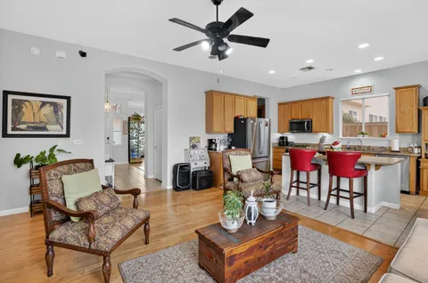 a living room with furniture kitchen view and a dining table