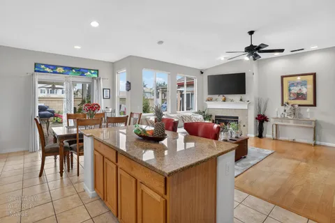 a living room with furniture a flat screen tv and kitchen view