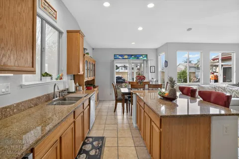 a kitchen with sink a counter top space and living room