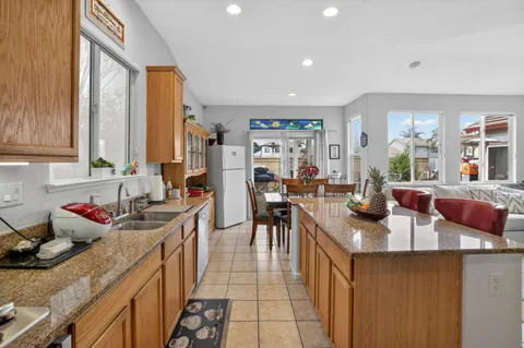 a kitchen with sink a stove and cabinets