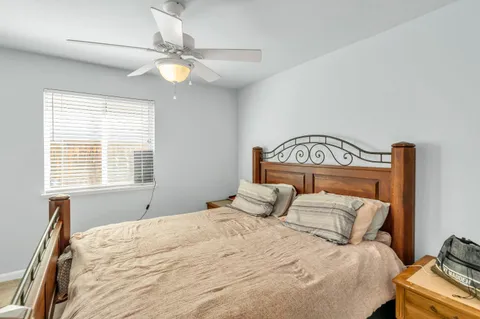 a bedroom with a bed and a window