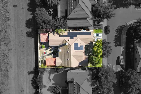 an aerial view of a house with outdoor space