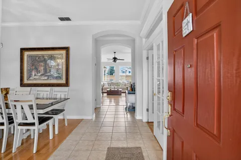 a hallway with a dining table and chairs