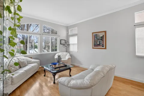 a living room with furniture and painting on the wall