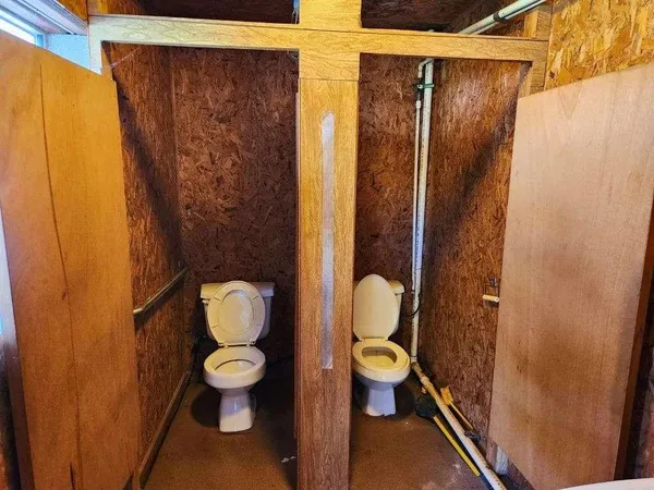 a living room with furniture a pool table and a fireplace