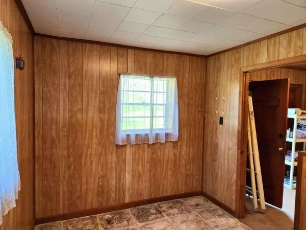 a bedroom with furniture and a window