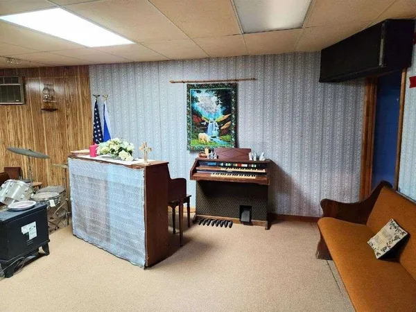 a view of a hallway with wooden floor and door