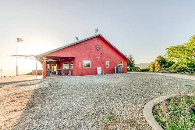 a living room with furniture a fireplace and a chandelier