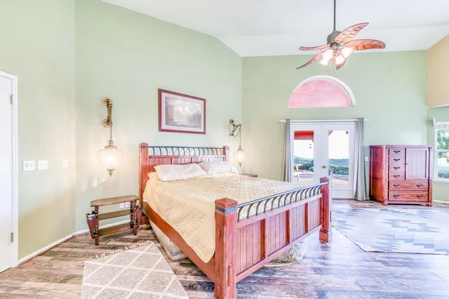 a view of a dining room with furniture a chandelier and wooden floor
