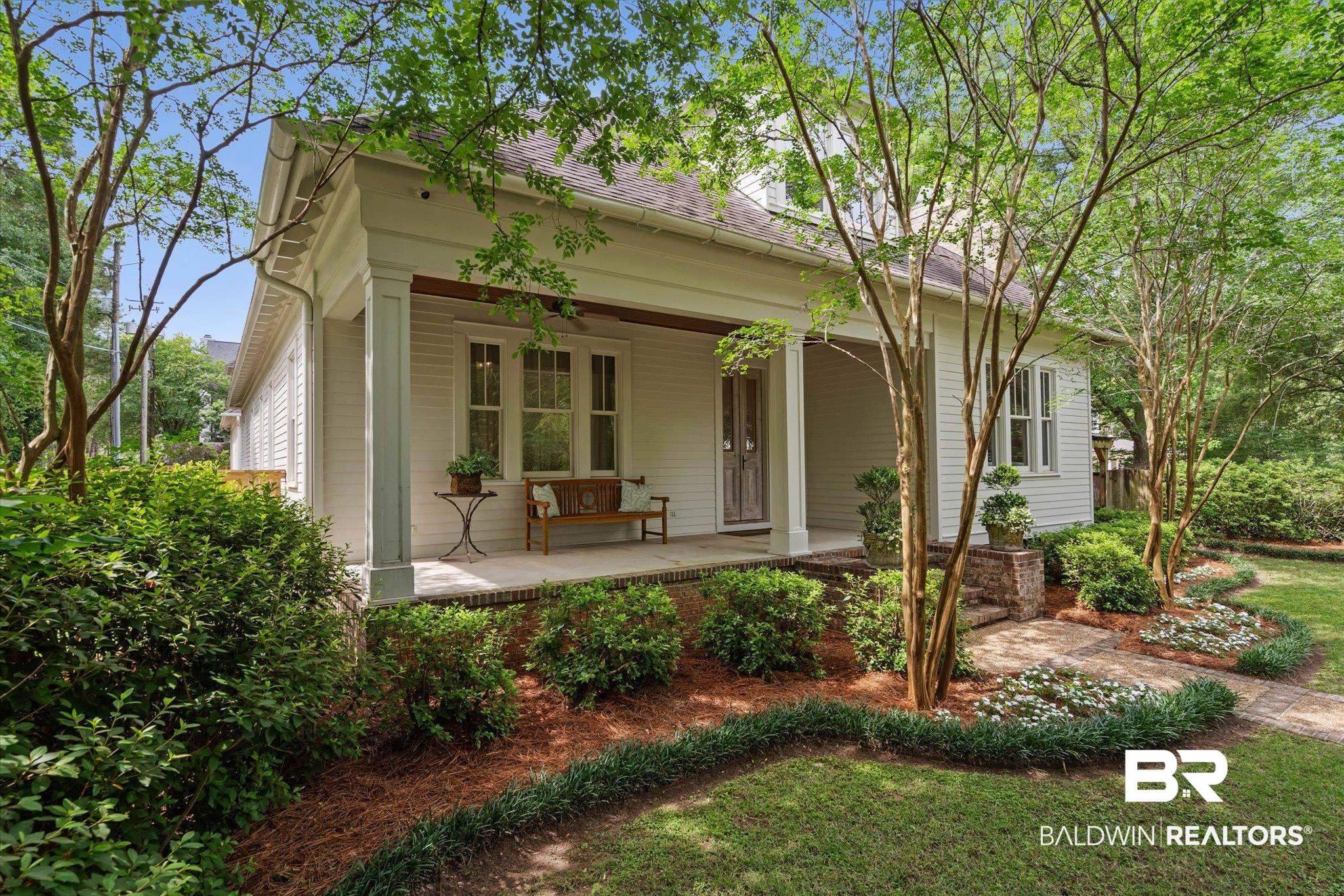 3813 Austill Lane Mobile, AL 36608 - Photo 32 of 37 Front facade featuring white siding, a covered porch with square columns, and a front entry door with vertical panels