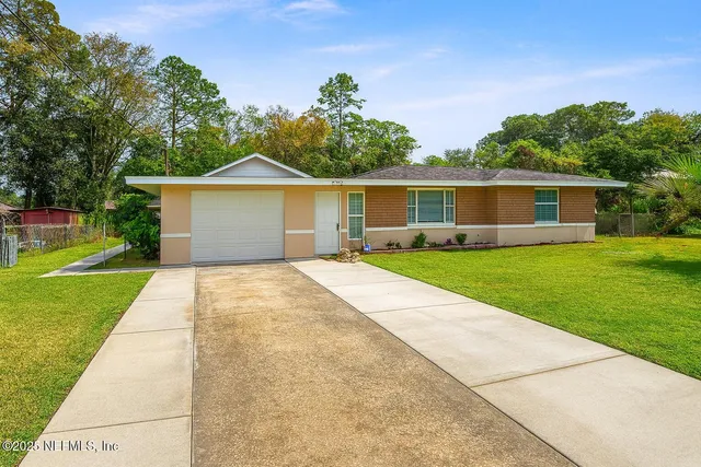 a front view of house with yard and green space