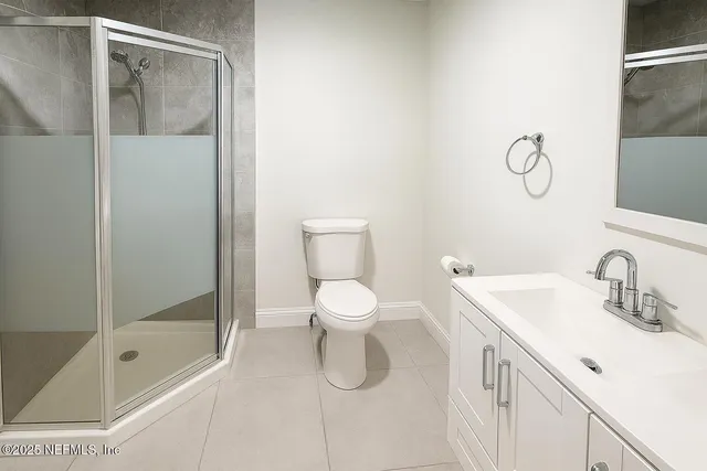 a bedroom with a bed and a potted plant