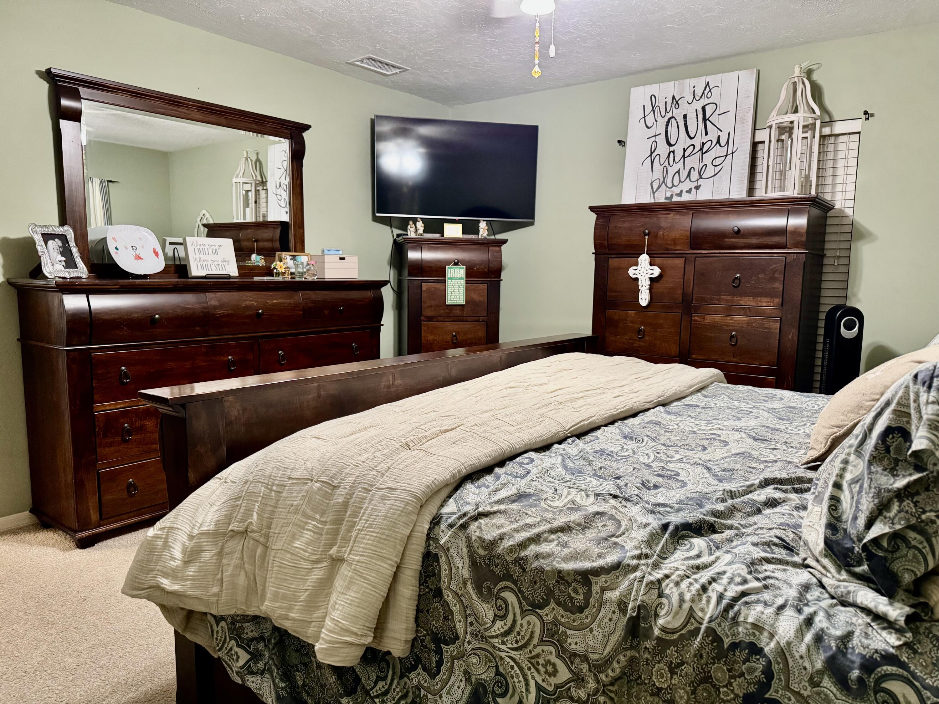 603 Southwest 15th Street Okeechobee, FL 34974 - Photo 15 of 40 a bedroom with a bed and a flat screen tv