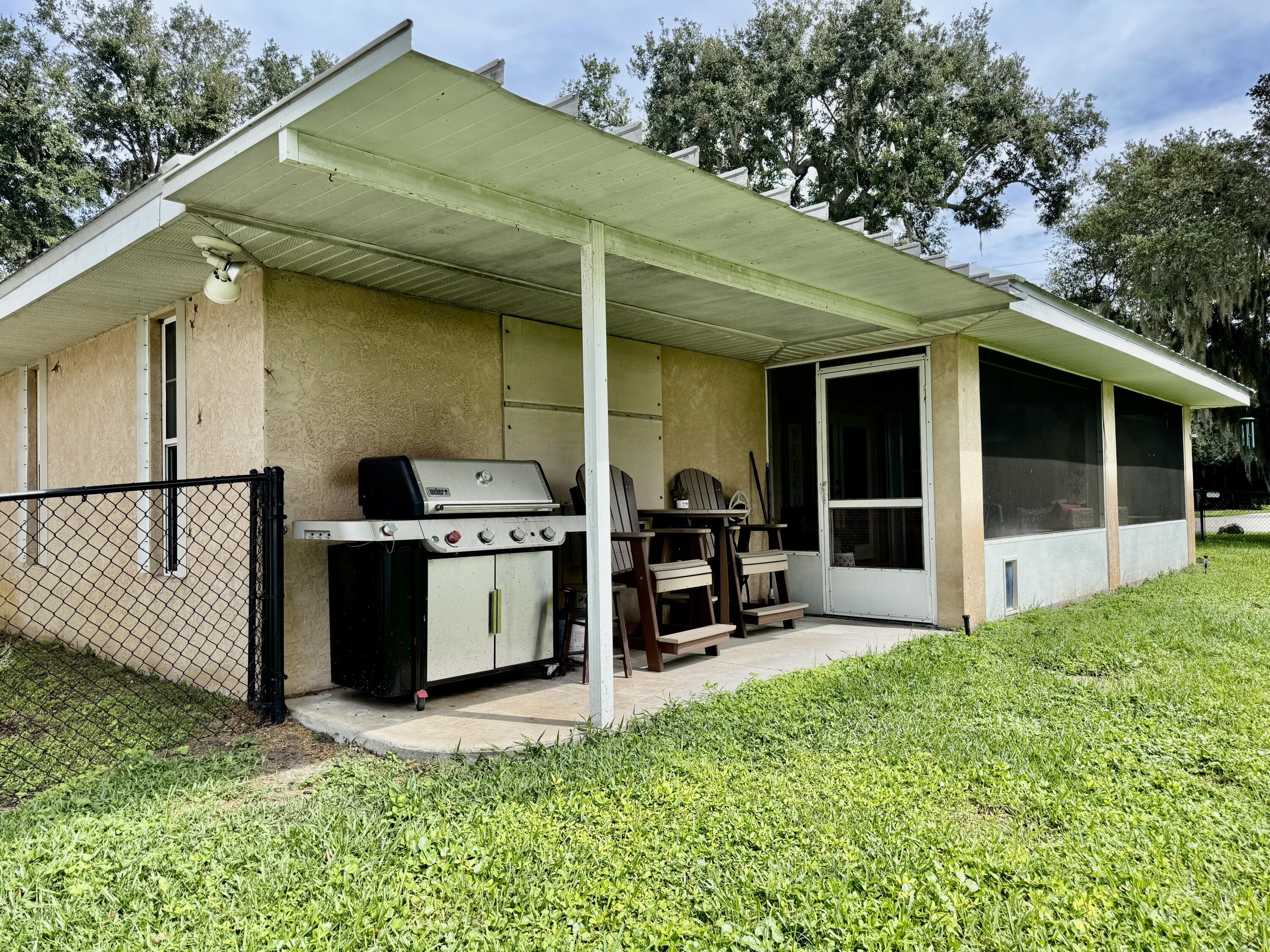 603 Southwest 15th Street Okeechobee, FL 34974 - Photo 32 of 40 a view of a backyard with a patio and a garden