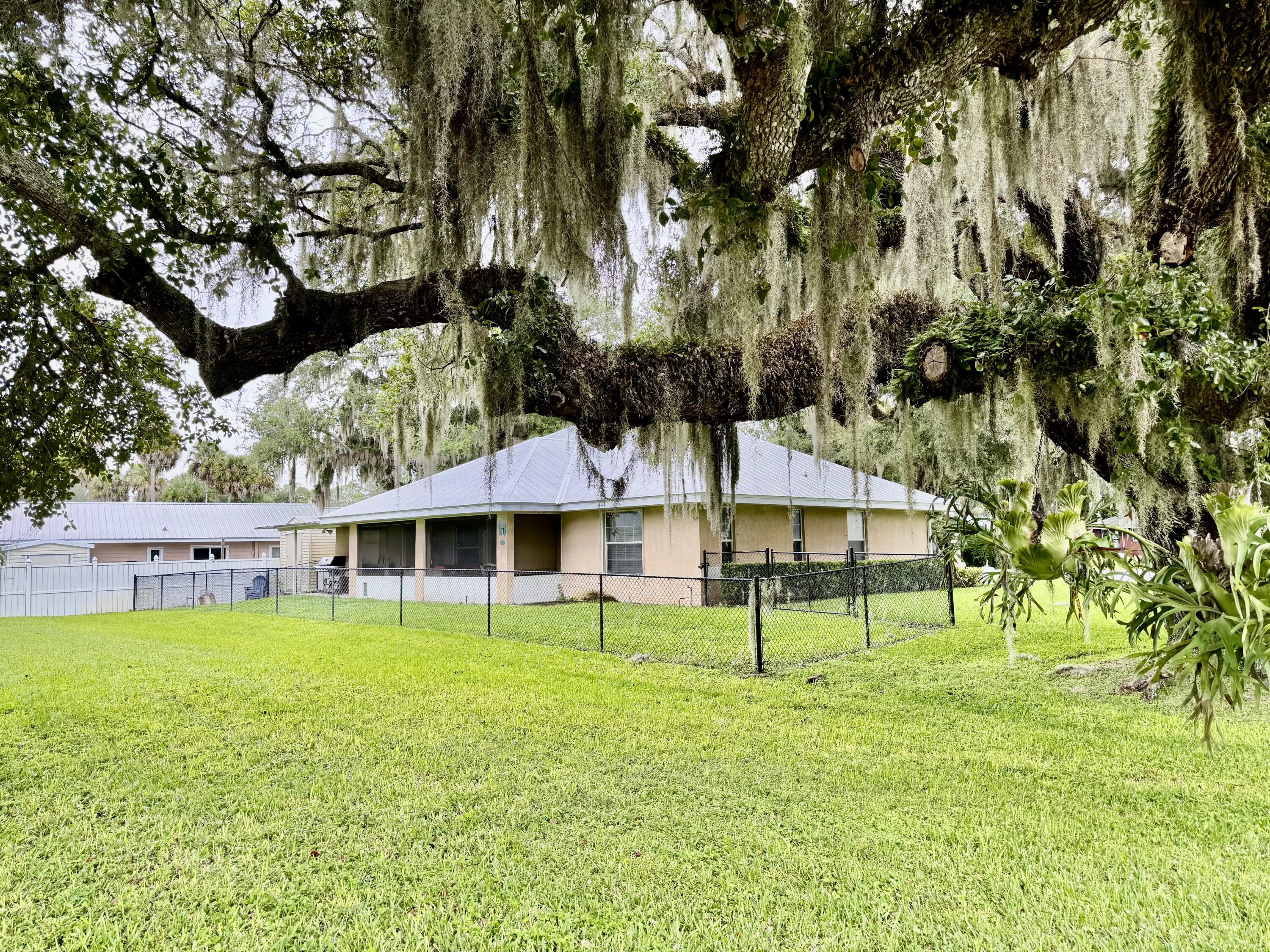 603 Southwest 15th Street Okeechobee, FL 34974 - Photo 39 of 40 a view of a house with a yard table and chairs