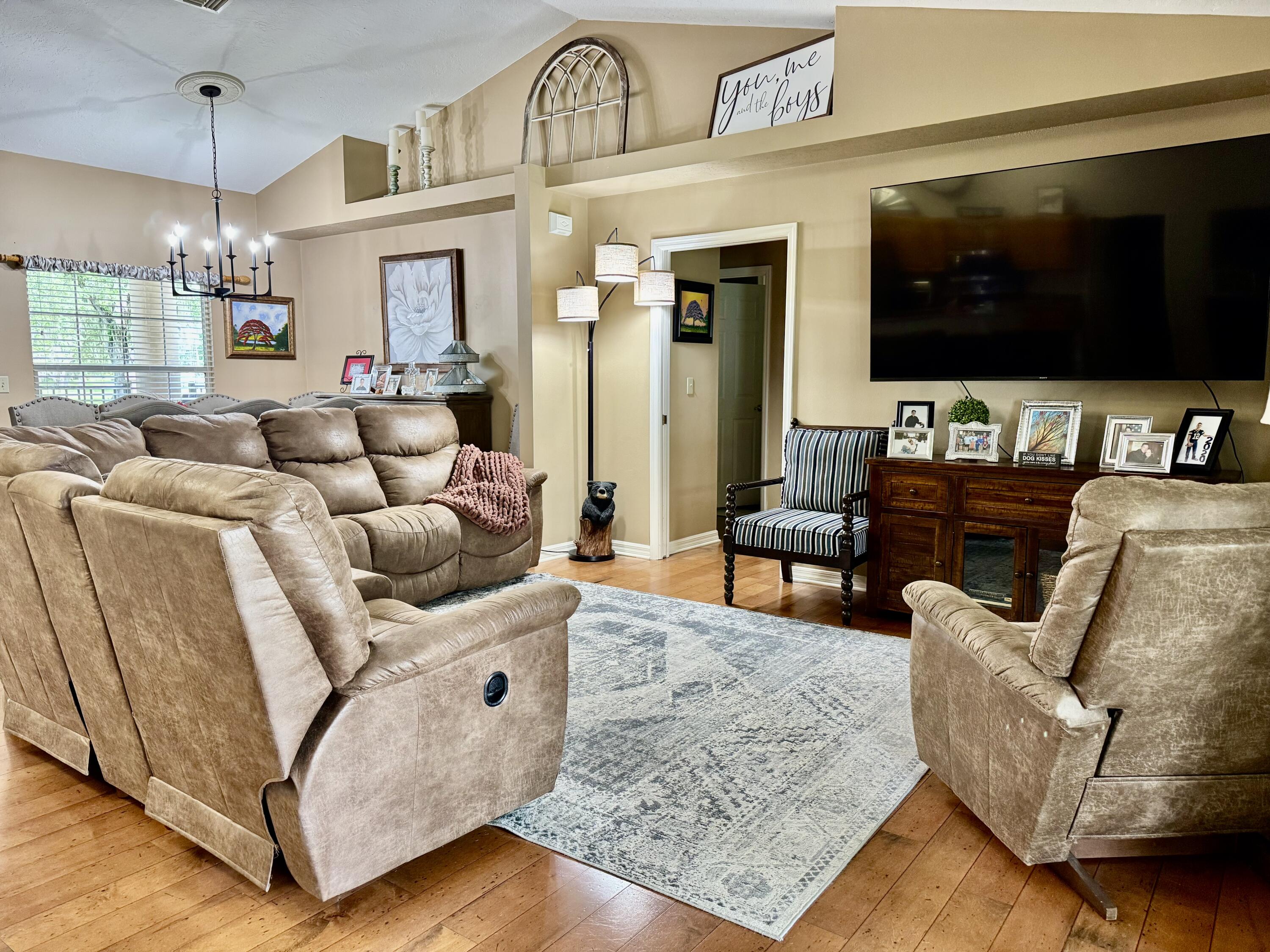 603 Southwest 15th Street Okeechobee, FL 34974 - Photo 8 of 40 a living room with furniture and a flat screen tv