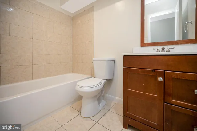a bathroom with a toilet a sink and bathtub