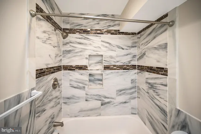 a bathroom with a shower and a bath tub