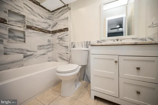a bathroom with a toilet a sink and bathtub