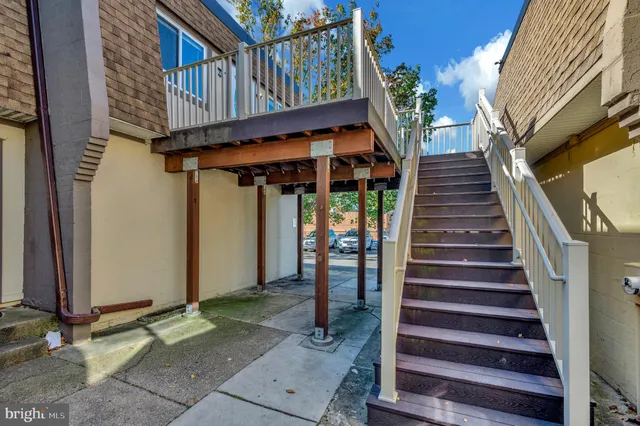 a view of a pathway with a wooden fence