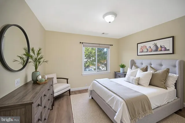 a bedroom with a large bed and a chandelier