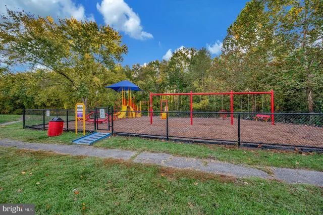 a backyard of a house with potted plants and a table and chairs