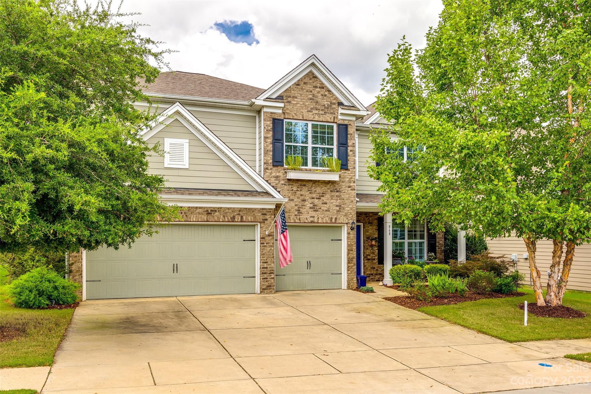 868 Coralbell Way Tega Cay, SC 29708 - Photo 1 of 45 a front view of a house with a yard and a garage