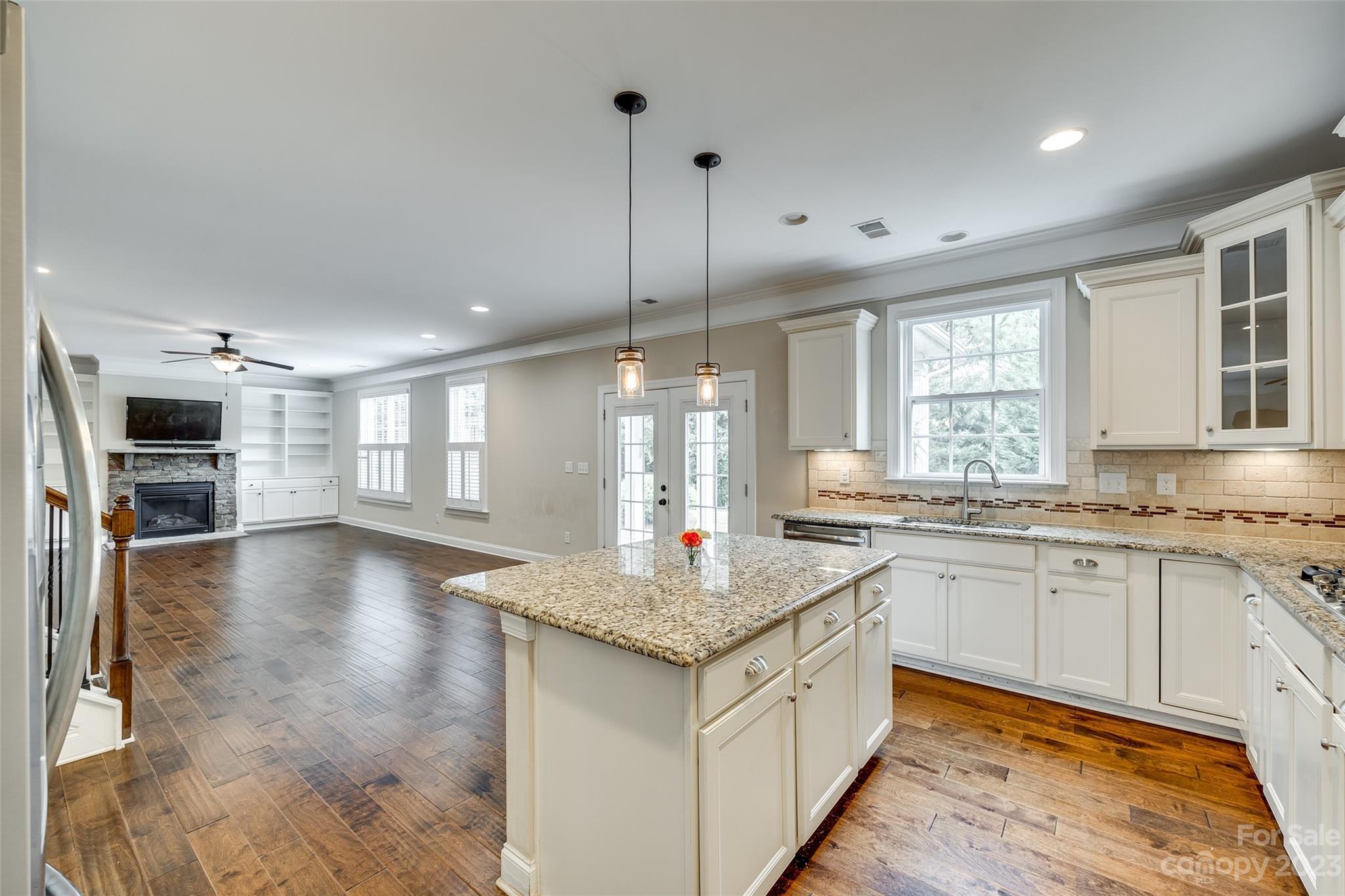 868 Coralbell Way Tega Cay, SC 29708 - Photo 15 of 45 a kitchen with granite countertop a stove sink and cabinets