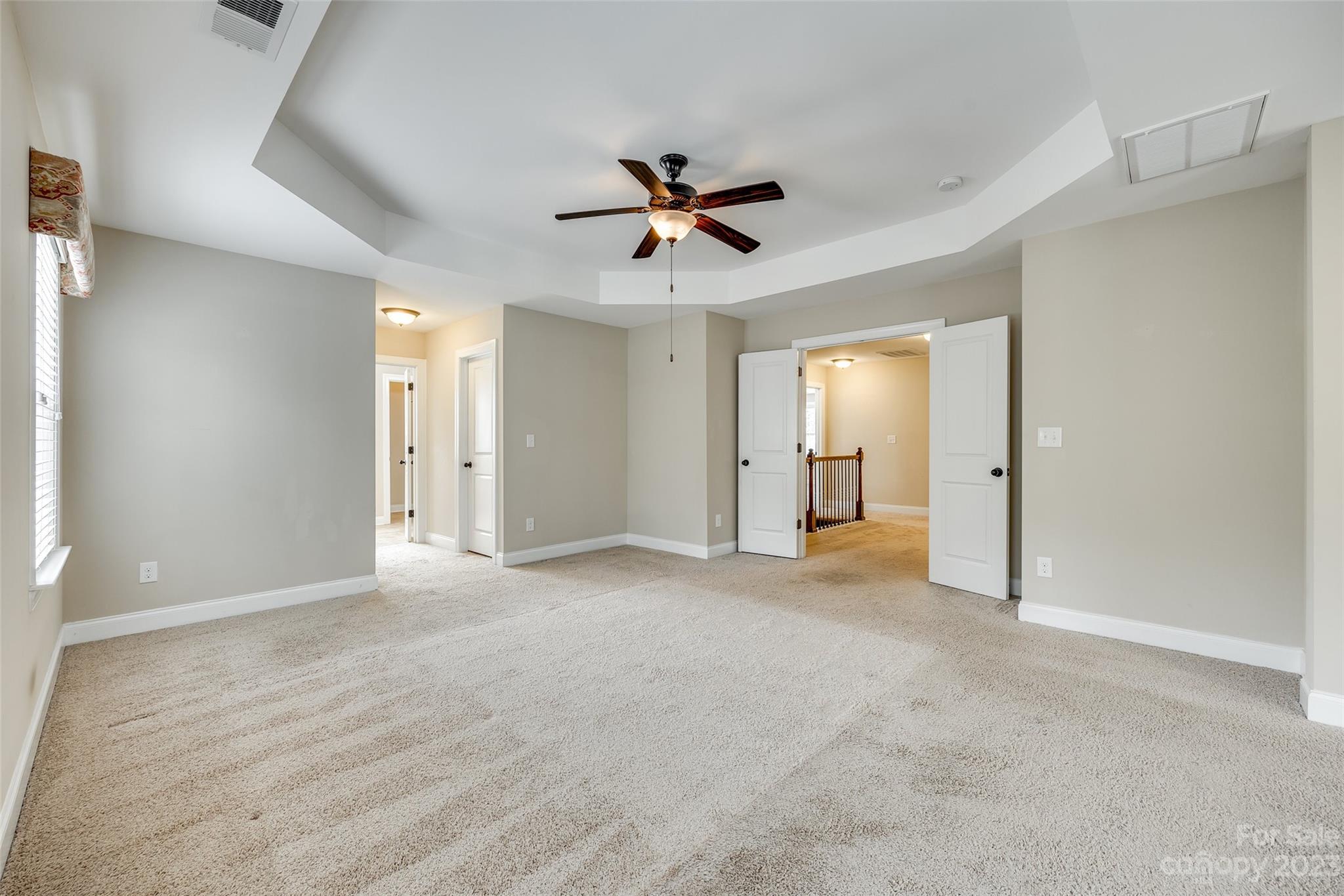 868 Coralbell Way Tega Cay, SC 29708 - Photo 24 of 45 an empty room with closet and a ceiling fan