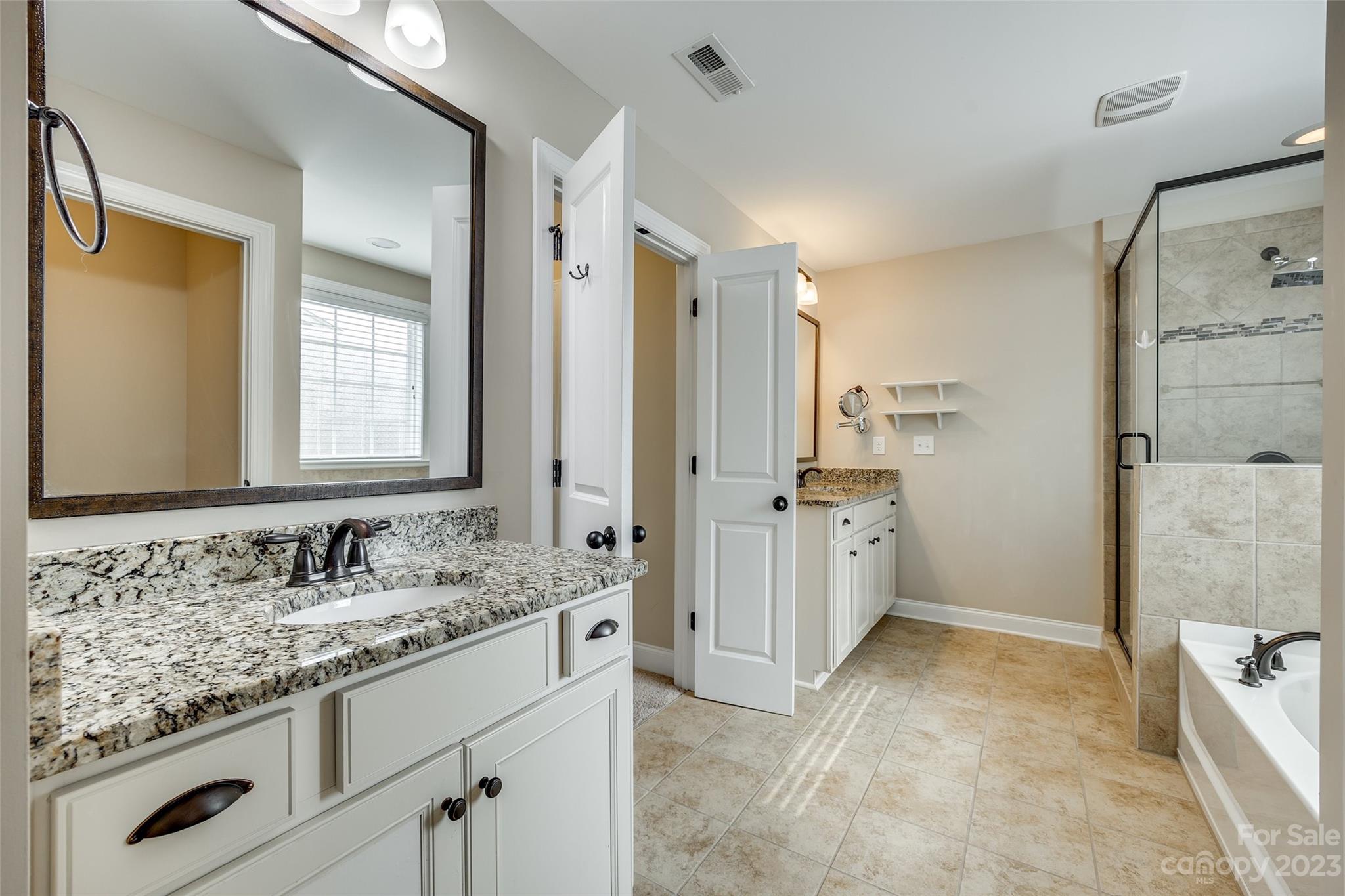 868 Coralbell Way Tega Cay, SC 29708 - Photo 25 of 45 a bathroom with a granite countertop sink mirror and a