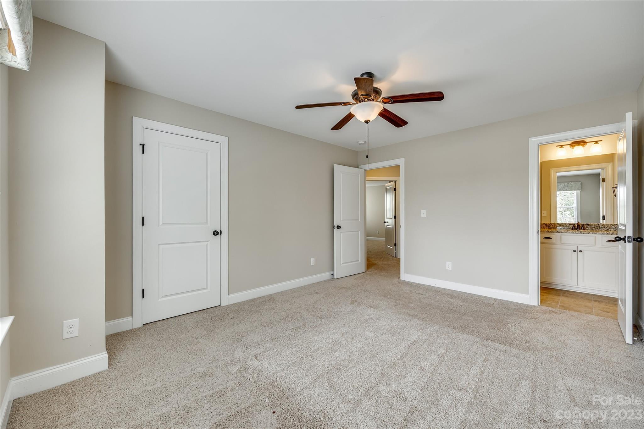 868 Coralbell Way Tega Cay, SC 29708 - Photo 31 of 45 a view of empty room with wooden floor and ceiling fan
