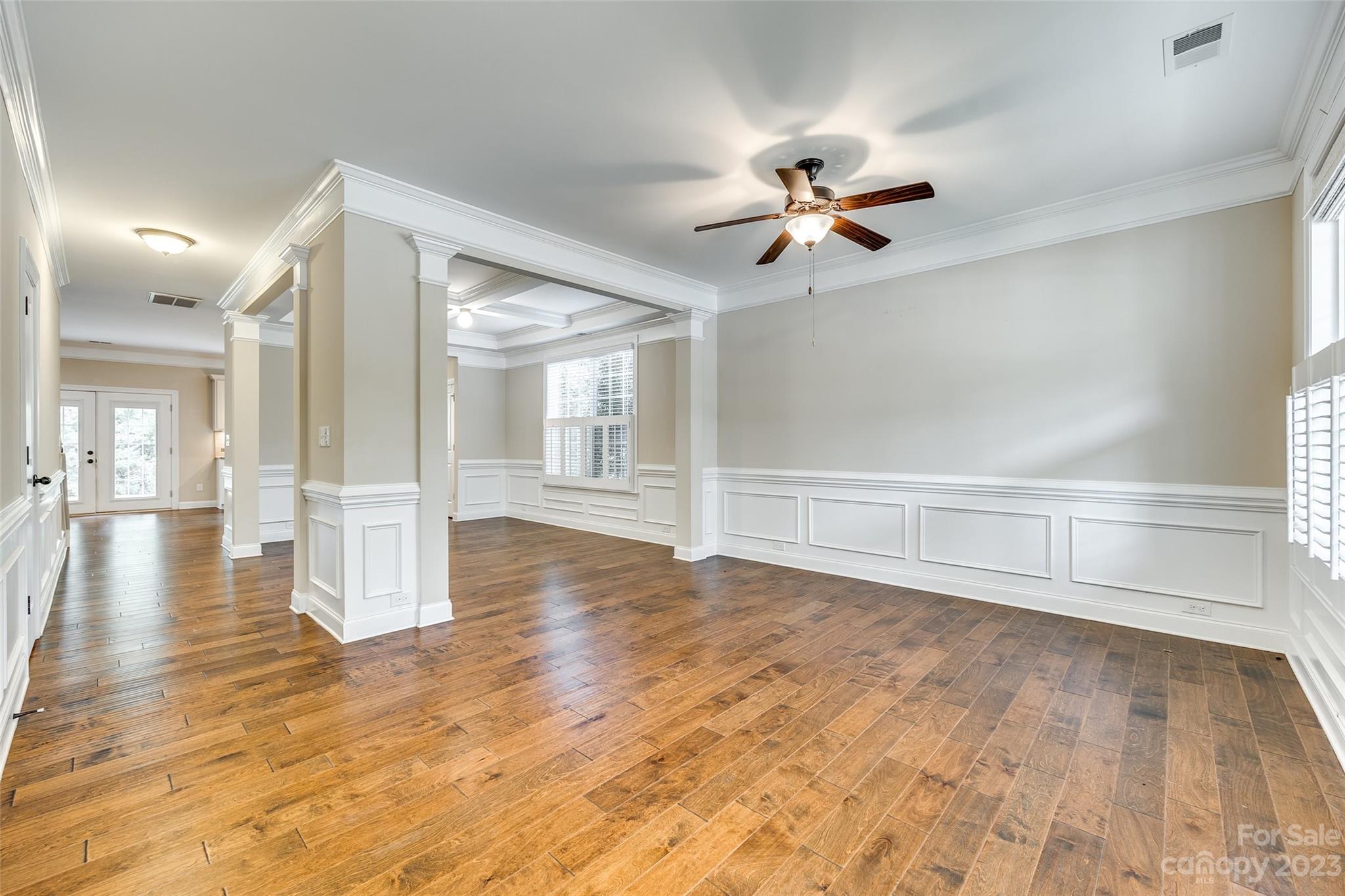 868 Coralbell Way Tega Cay, SC 29708 - Photo 8 of 45 a view of a livingroom with a ceiling fan wooden floor and a ceiling fan